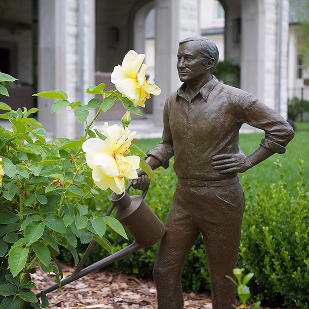 Man Watering Statue